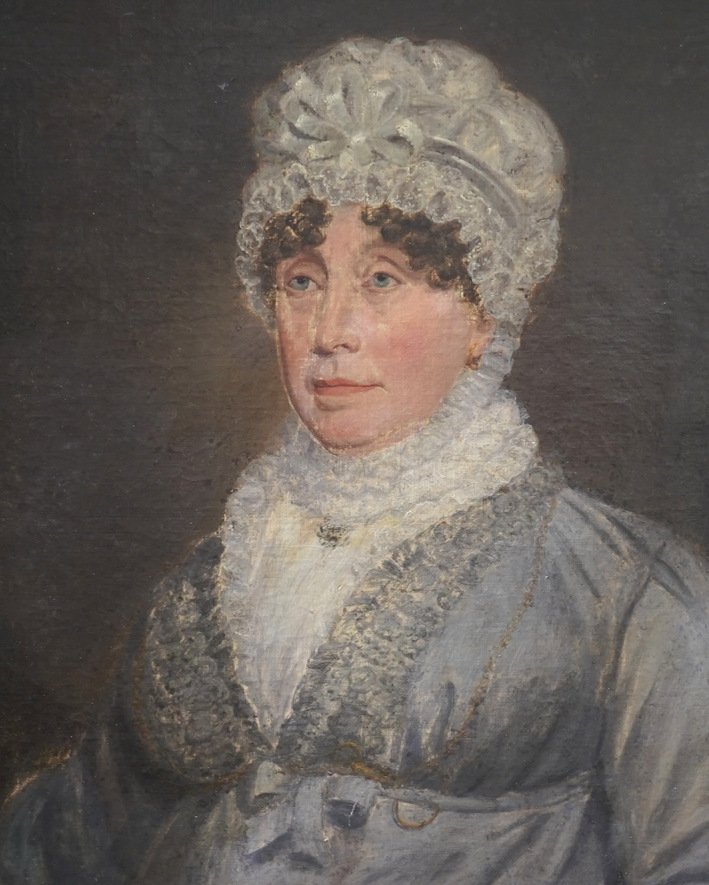 Victorian School, Half length portrait of an elderly lady wearing a lace cap, blouse and a grey dress, unsigned, oil on canvas, ornate gilt frame, 75 x 62cm